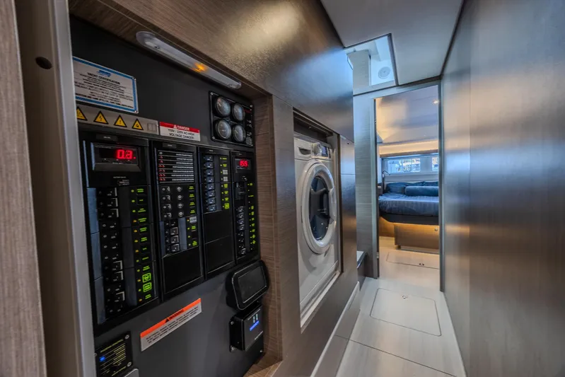  Yacht Photos Pics 2024 Leopard 53 Powercat interior with control panel and laundry area.