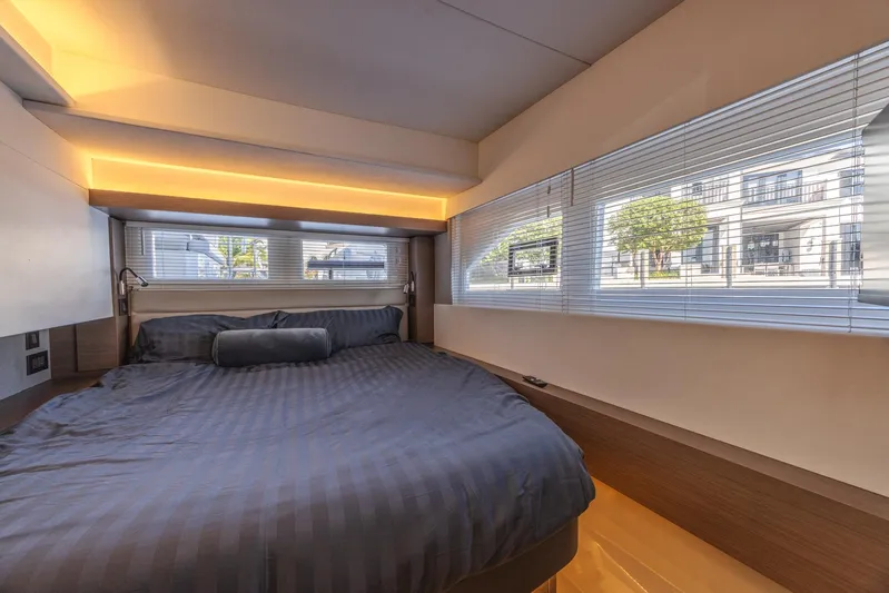  Yacht Photos Pics Luxurious bedroom interior of 2024 Leopard 53 Powercat yacht with modern design and large windows.