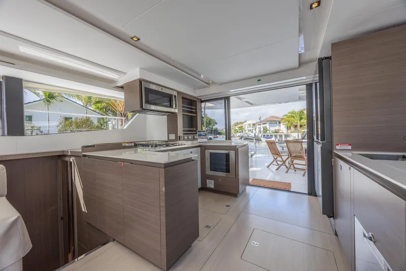  Yacht Photos Pics Luxurious kitchen interior of 2024 Leopard 53 Powercat yacht with modern appliances and outdoor view.