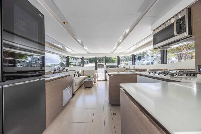  Yacht Photos Pics Luxurious interior of 2024 Leopard 53 Powercat yacht with modern kitchen and seating area.