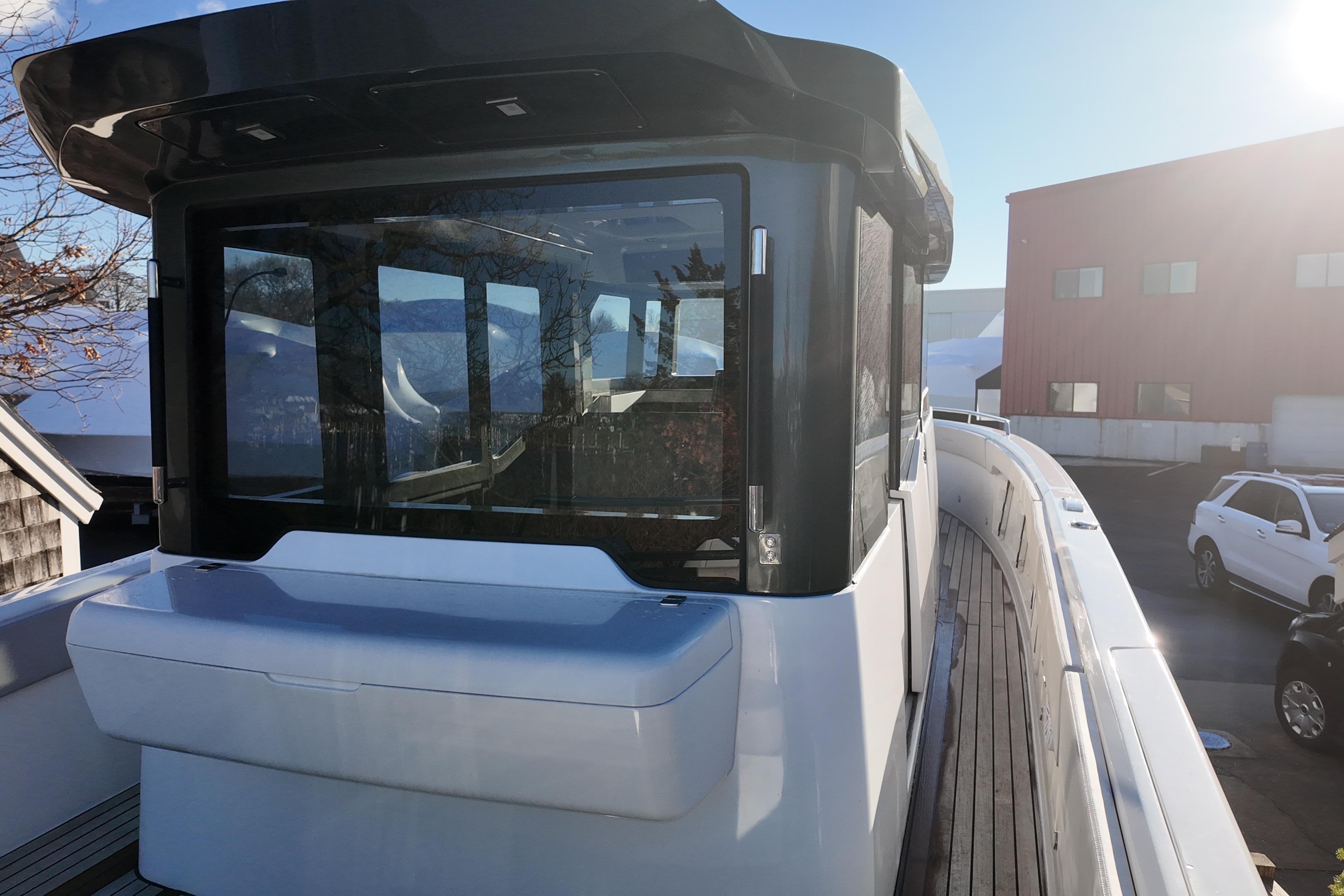 2024 Schaefer V33 yacht with sleek design and modern windows, docked in a sunny marina.