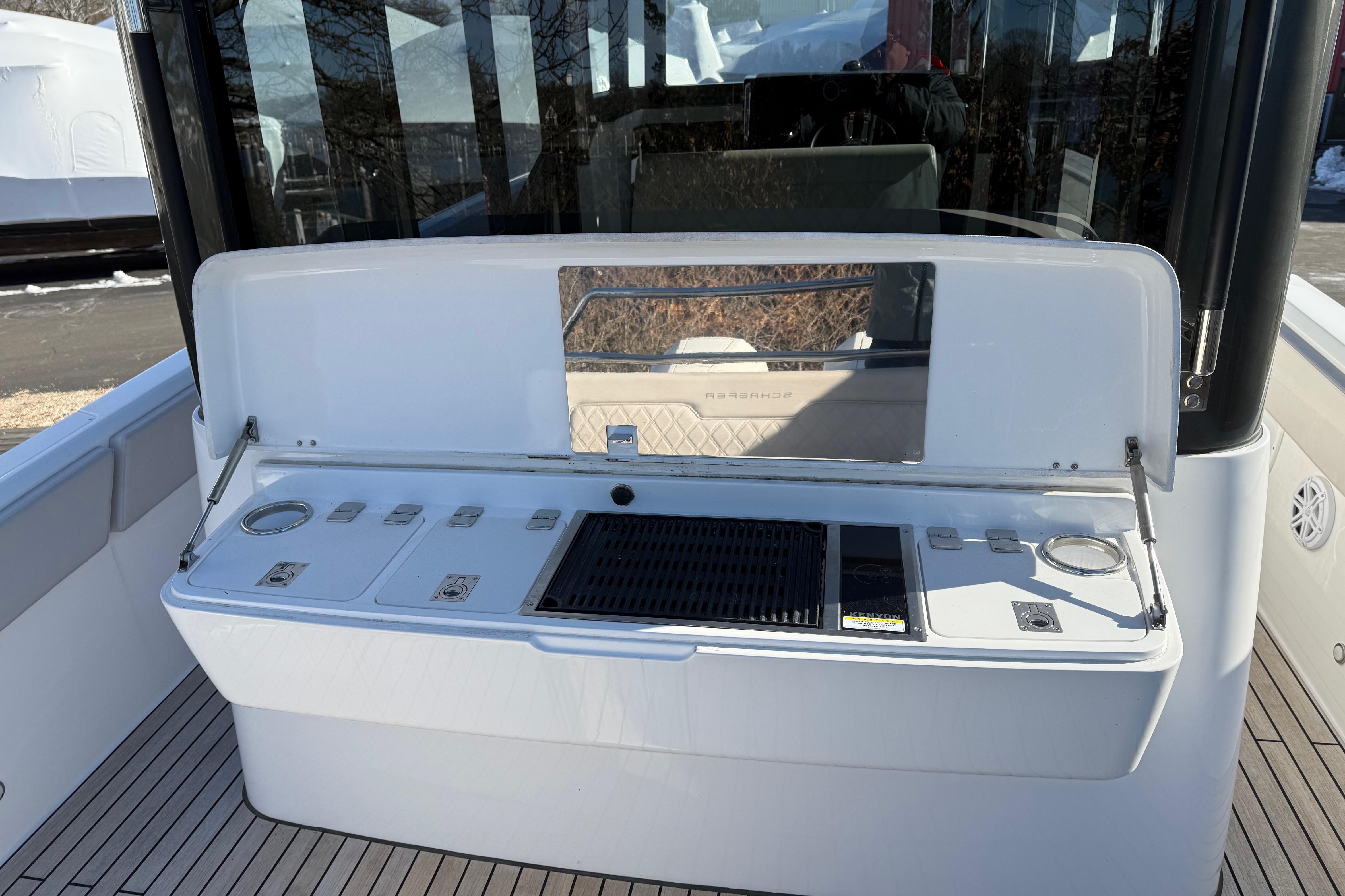 2024 Schaefer V33 boat with outdoor kitchen and grill setup.