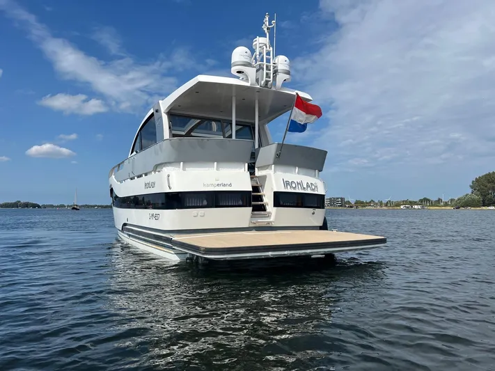  Yacht Photos Pics Vripack Utopia 58 yacht, 2013 model, on water with Dutch flag, clear sky.