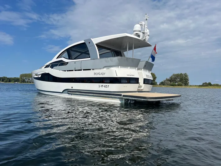  Yacht Photos Pics Luxury Vripack Utopia 58 yacht from 2013 on calm water, featuring sleek design and Dutch flag.