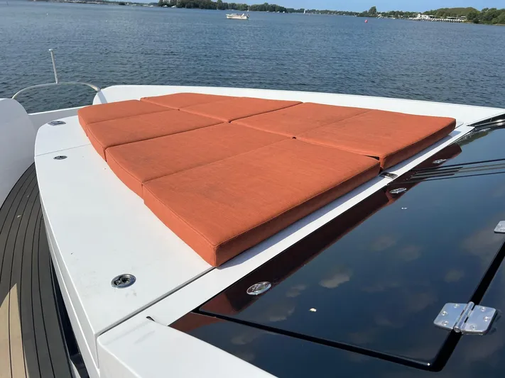  Yacht Photos Pics Luxurious Vripack Utopia 58 yacht with orange sunbathing cushions, 2013 model, on serene water.