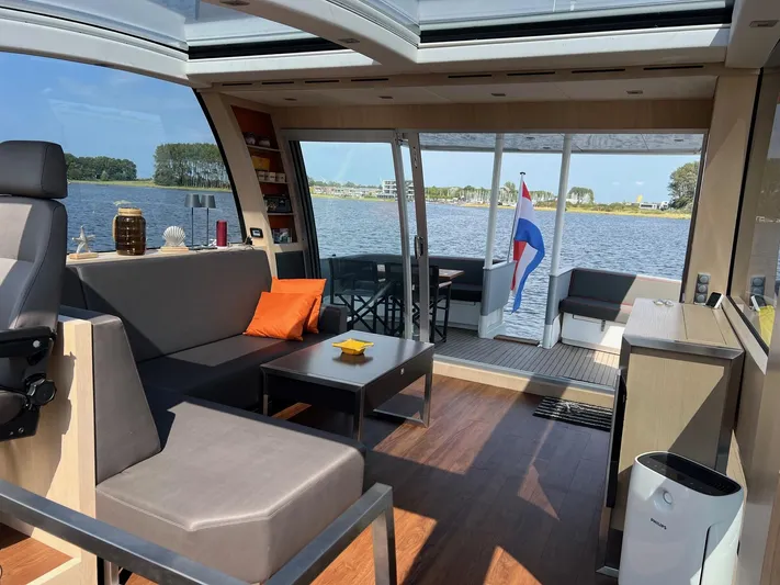  Yacht Photos Pics Luxurious Vripack Utopia 58 yacht interior with modern seating, panoramic windows, and scenic water view.