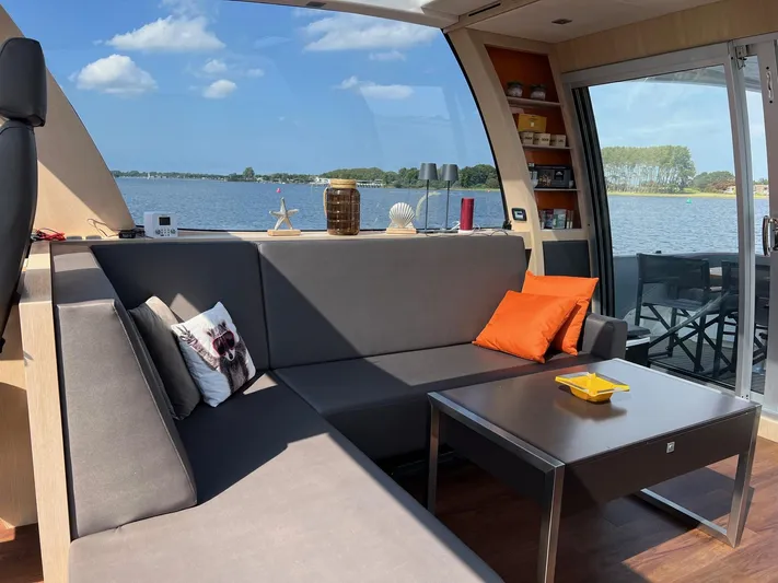  Yacht Photos Pics Luxurious Vripack Utopia 58 yacht interior with modern seating, table, and scenic water view.