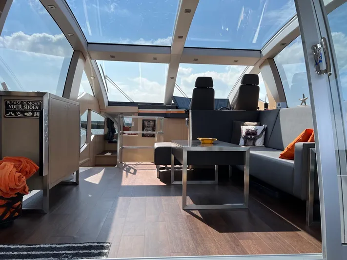  Yacht Photos Pics Luxurious interior of 2013 Vripack Utopia 58 yacht with modern seating and panoramic windows.