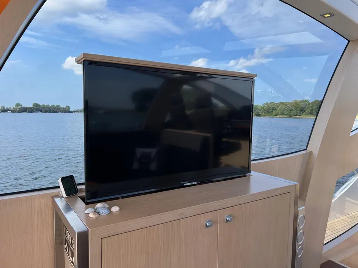  Yacht Photos Pics Luxury yacht interior with TV, Vripack Utopia 58, 2013 model, scenic water view.
