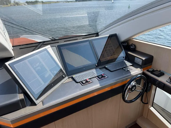  Yacht Photos Pics Helm of 2013 Vripack Utopia 58 yacht with modern navigation screens and controls.