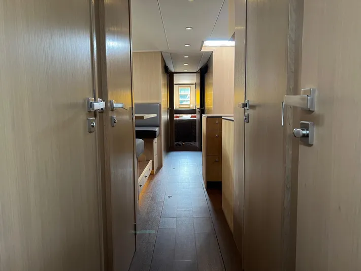  Yacht Photos Pics Interior hallway of 2013 Vripack Utopia 58 yacht, featuring modern wood finishes.