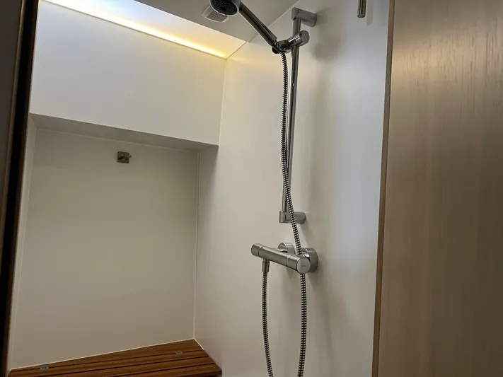  Yacht Photos Pics Modern shower area in 2013 Vripack Utopia 58 yacht with sleek fixtures and wooden bench.