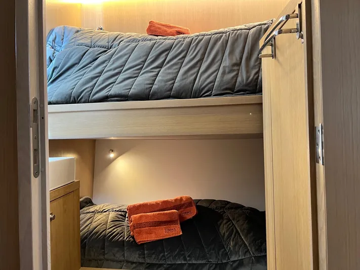  Yacht Photos Pics Bunk beds in a 2013 Vripack Utopia 58 yacht cabin with cozy lighting and orange towels.