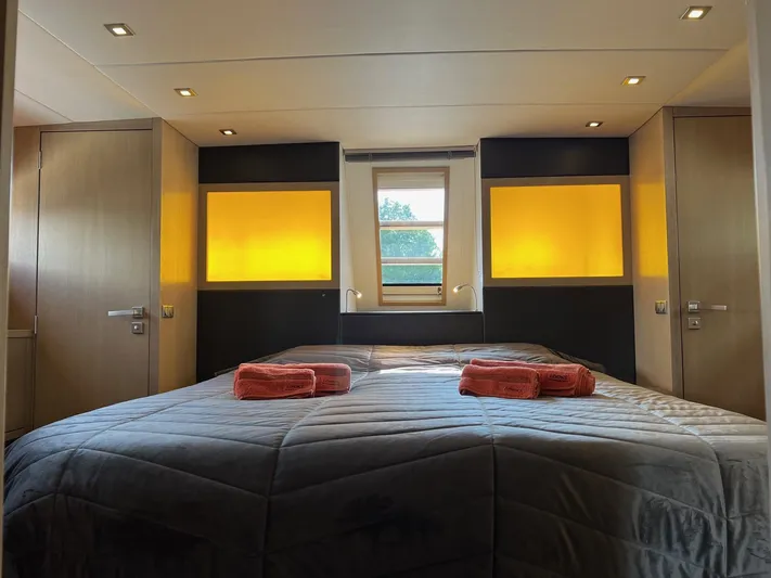  Yacht Photos Pics Luxurious bedroom interior of 2013 Vripack Utopia 58 yacht with cozy lighting and elegant bedding.