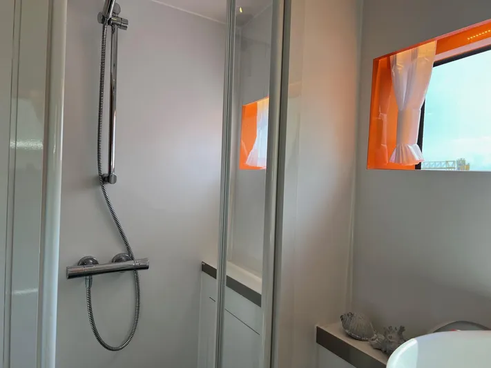  Yacht Photos Pics Modern bathroom with shower in 2013 Vripack Utopia 58 yacht, featuring sleek design and bright window.