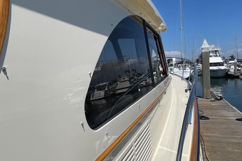 White Sauce Yacht Photos Pics 2017 Hinckley Talaria 43 Motoryacht docked at marina, showcasing sleek design and reflective windows.