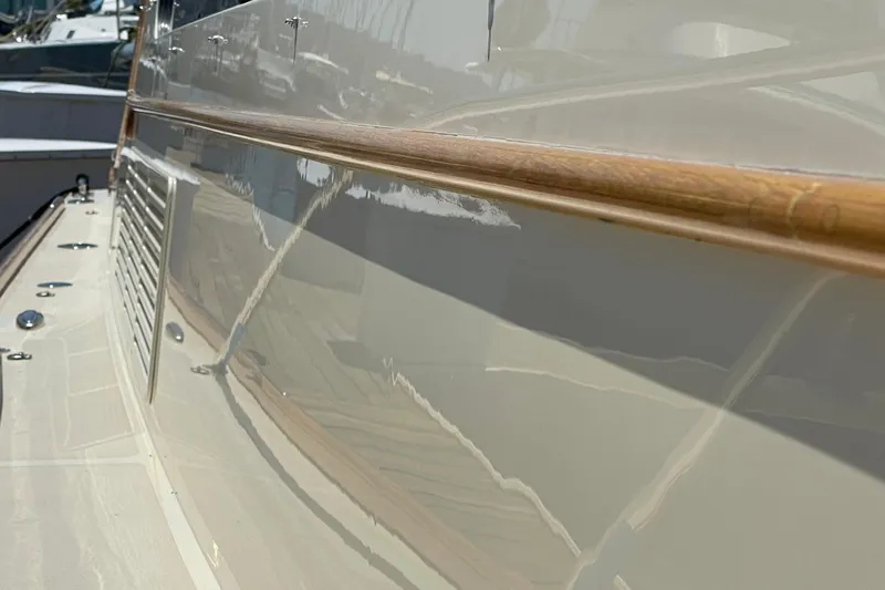 White Sauce Yacht Photos Pics 2017 Hinckley Talaria 43 Motoryacht, sleek side view with polished wood detail.