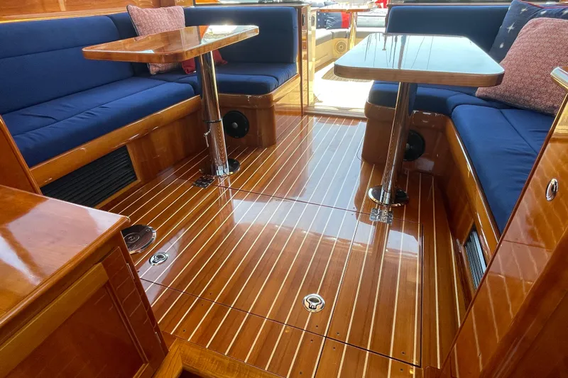 White Sauce Yacht Photos Pics Luxurious interior of 2017 Hinckley Talaria 43 Motoryacht with polished wood and blue seating.