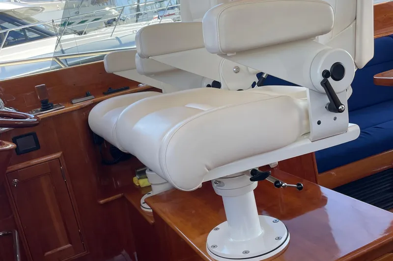 White Sauce Yacht Photos Pics Luxurious helm seat on 2017 Hinckley Talaria 43 Motoryacht, featuring elegant white upholstery.