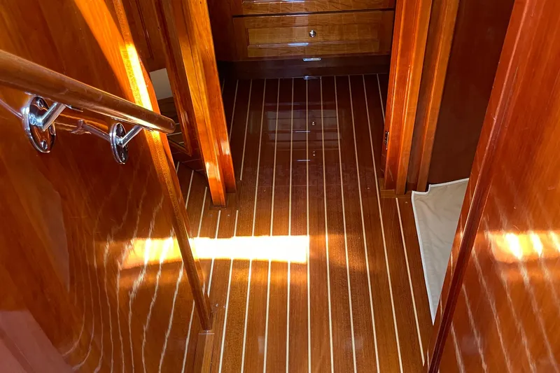 White Sauce Yacht Photos Pics Luxurious wooden interior of 2017 Hinckley Talaria 43 Motoryacht, featuring polished floors and cabinetry.