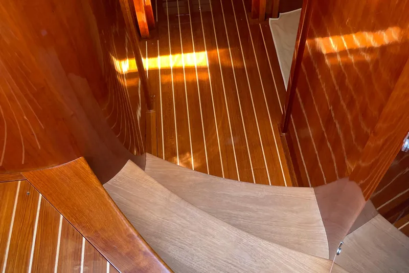 White Sauce Yacht Photos Pics Interior of 2017 Hinckley Talaria 43 Motoryacht with elegant wooden flooring and curved staircase.