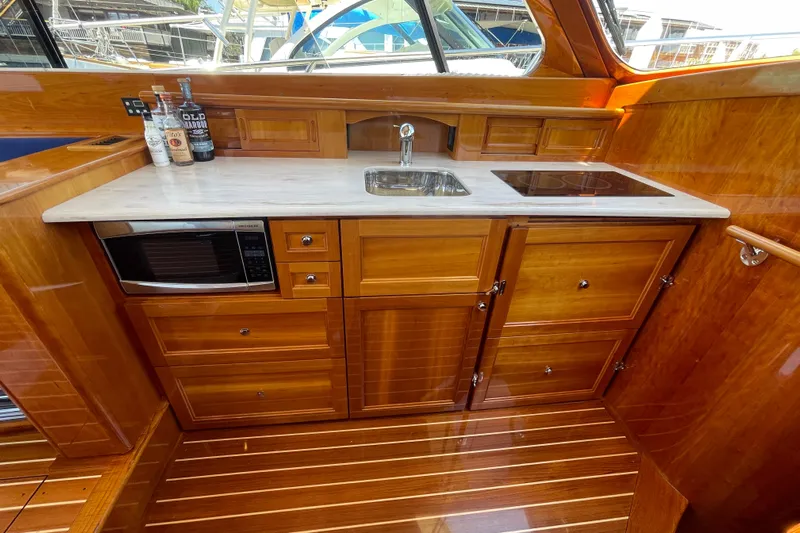 White Sauce Yacht Photos Pics Luxurious galley in 2017 Hinckley Talaria 43 Motoryacht with wood cabinetry and modern appliances.