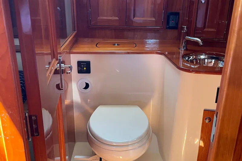 White Sauce Yacht Photos Pics Luxurious bathroom interior of 2017 Hinckley Talaria 43 Motoryacht with wooden cabinetry.