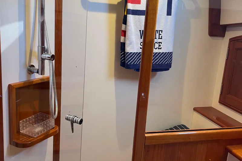 White Sauce Yacht Photos Pics Hinckley Talaria 43 Motoryacht 2017 bathroom with shower and nautical-themed towel.