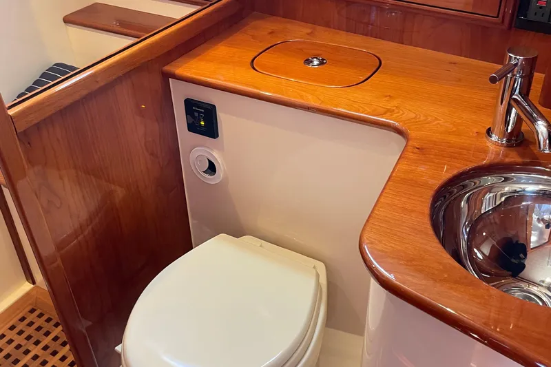 White Sauce Yacht Photos Pics Luxurious bathroom interior of 2017 Hinckley Talaria 43 Motoryacht with wood accents and modern fixtures.