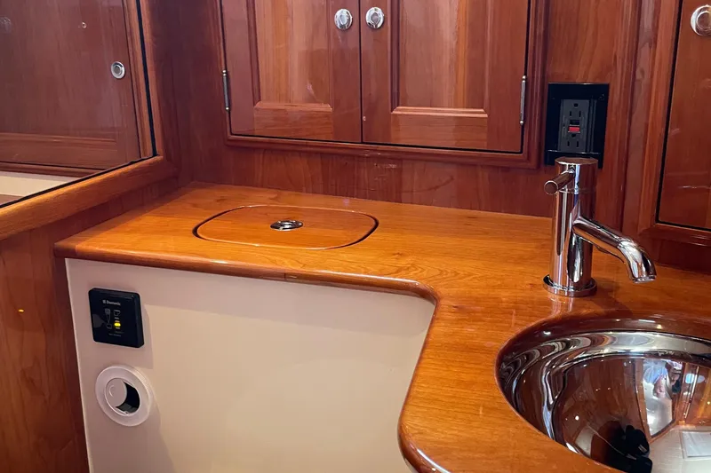 White Sauce Yacht Photos Pics Luxurious wooden interior of 2017 Hinckley Talaria 43 Motoryacht bathroom with sink and faucet.