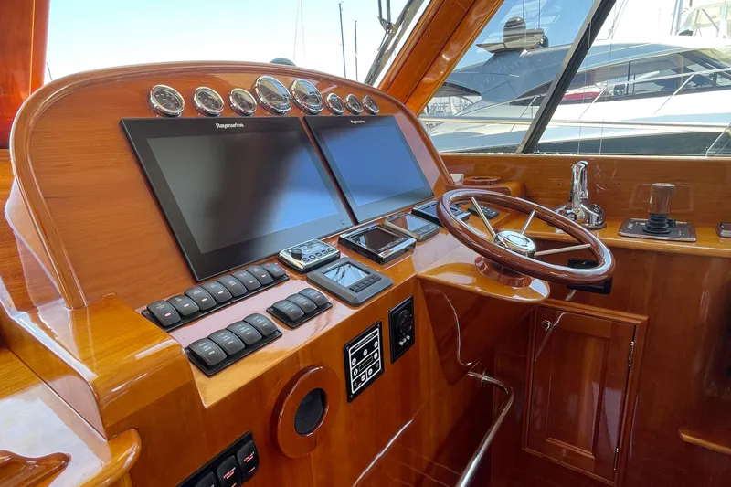 White Sauce Yacht Photos Pics 2017 Hinckley Talaria 43 Motoryacht helm with dual screens and wooden steering wheel.