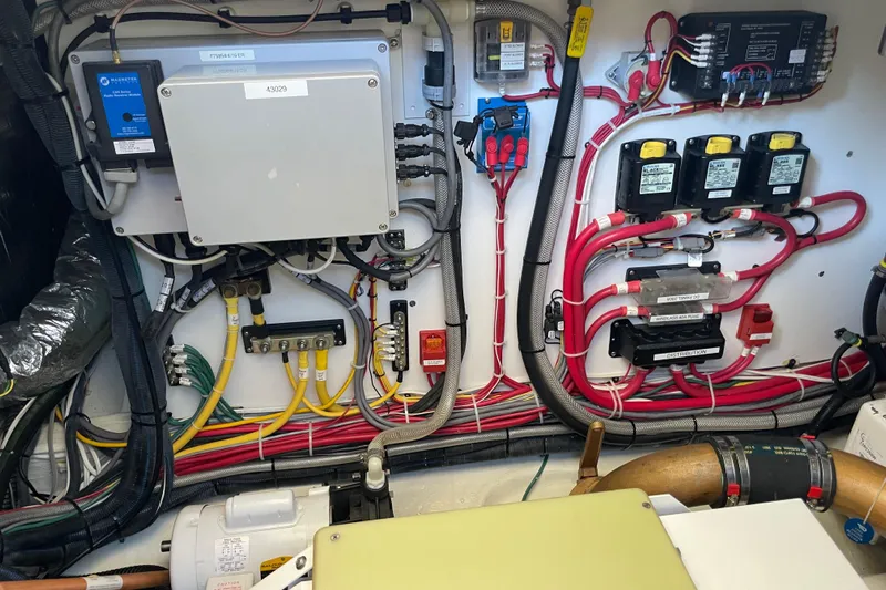 White Sauce Yacht Photos Pics Electrical system of a 2017 Hinckley Talaria 43 Motoryacht, showcasing organized wiring and components.