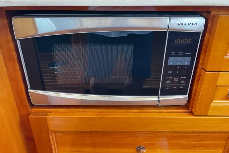 White Sauce Yacht Photos Pics Frigidaire microwave in 2017 Hinckley Talaria 43 Motoryacht kitchen, set in wooden cabinetry.