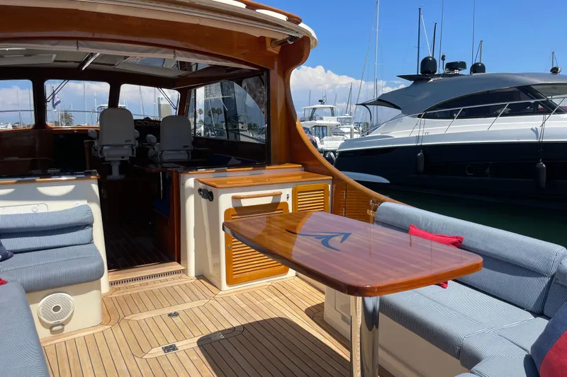 White Sauce Yacht Photos Pics 2017 Hinckley Talaria 43 Motoryacht interior with elegant seating and wooden table.