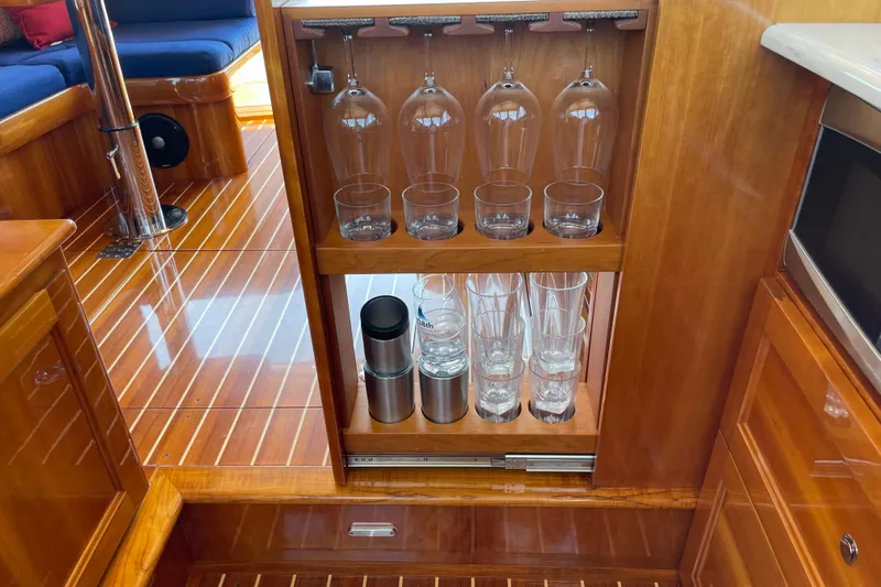 White Sauce Yacht Photos Pics Luxurious interior of 2017 Hinckley Talaria 43 Motoryacht with elegant glassware storage.