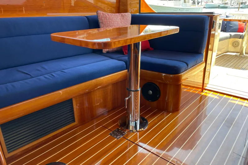 White Sauce Yacht Photos Pics Luxurious interior of 2017 Hinckley Talaria 43 Motoryacht with polished wood and blue seating.