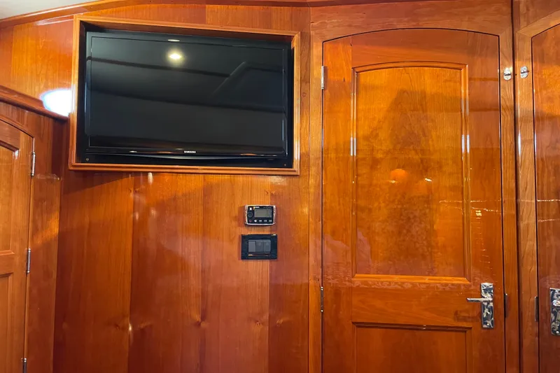 White Sauce Yacht Photos Pics Hinckley Talaria 43 Motoryacht 2017 interior with wood paneling and mounted TV.