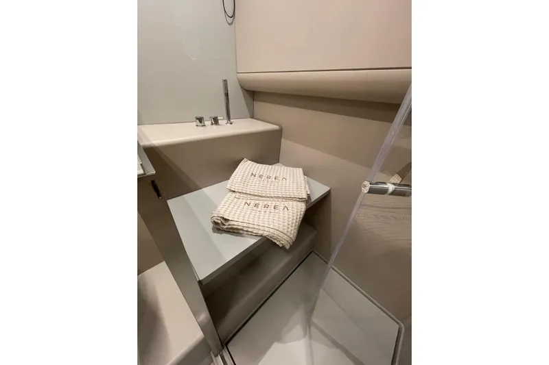  Yacht Photos Pics Elegant bathroom in 2024 Nerea Yacht NY40 with modern sink and branded towels.