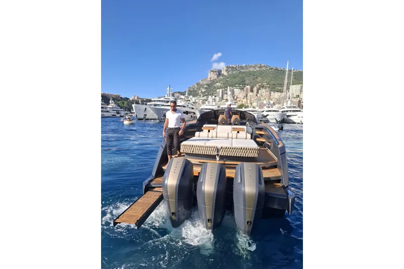  Yacht Photos Pics 2024 Nerea Yacht NY40 cruising in a scenic harbor with luxury yachts and cityscape.