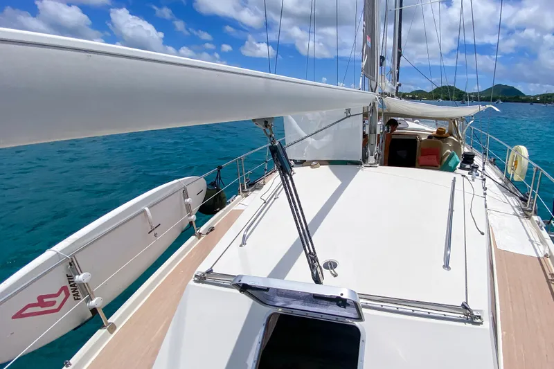  Yacht Photos Pics Sailing yacht Amel Super Maramu 1991 on clear blue water under a sunny sky.