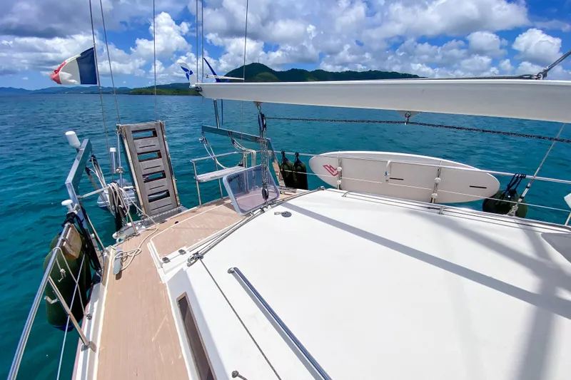  Yacht Photos Pics Sailing yacht Amel Super Maramu 1991 on clear blue water with scenic island backdrop.