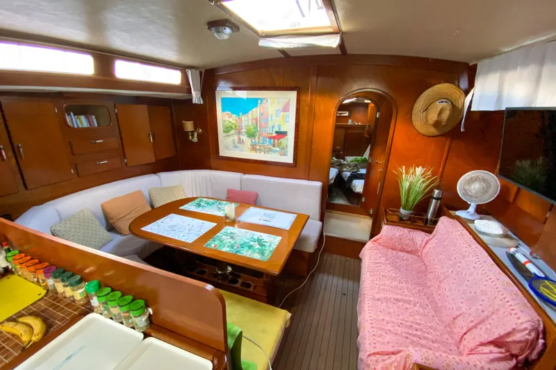  Yacht Photos Pics Interior of 1991 Amel Super Maramu yacht with cozy seating and wooden decor.