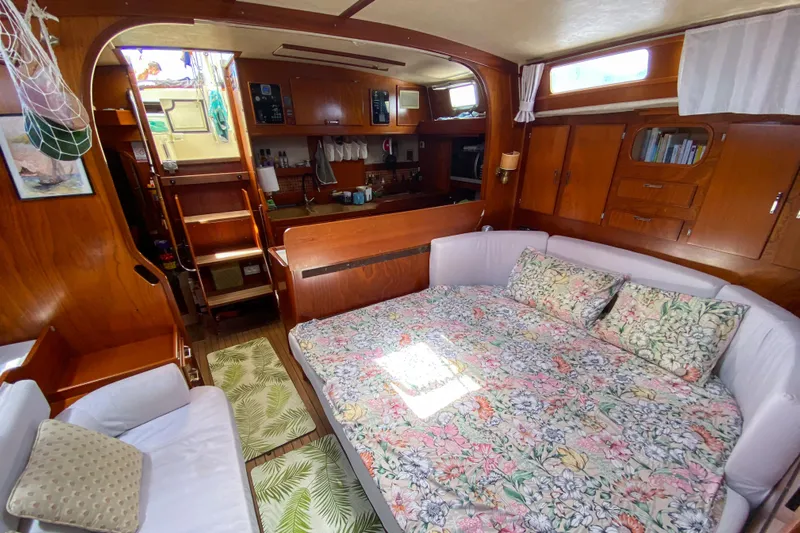  Yacht Photos Pics Interior of 1991 Amel Super Maramu yacht with cozy seating and floral bedding.
