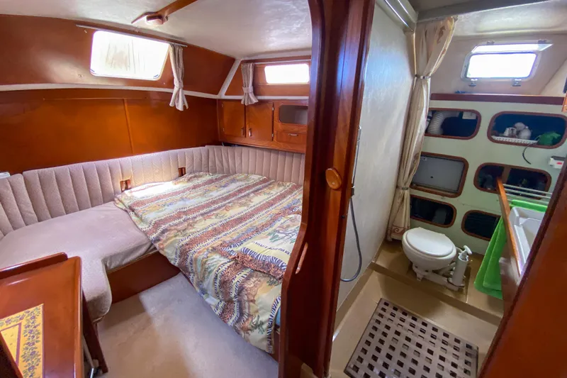  Yacht Photos Pics Cabin interior of 1991 Amel Super Maramu yacht with bed and bathroom.