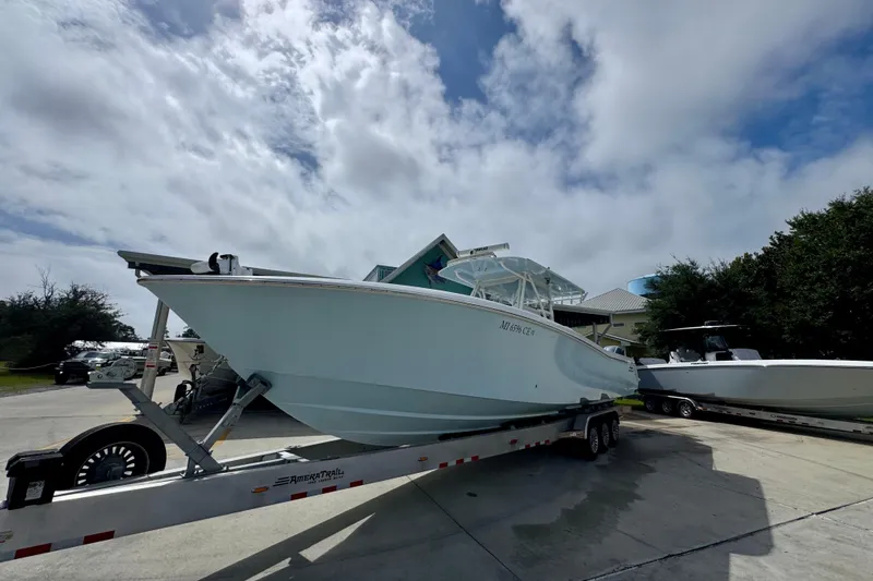 Yacht Photos Pics 2019 Invincible 39 Open Fisherman boat on trailer under cloudy sky.