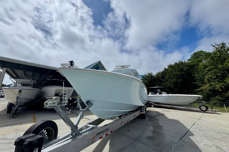  Yacht Photos Pics 2019 Invincible 39 Open Fisherman boat on trailer under cloudy sky.