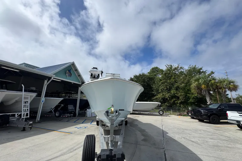  Yacht Photos Pics 2019 Invincible 39 Open Fisherman boat on trailer at marina under cloudy sky.