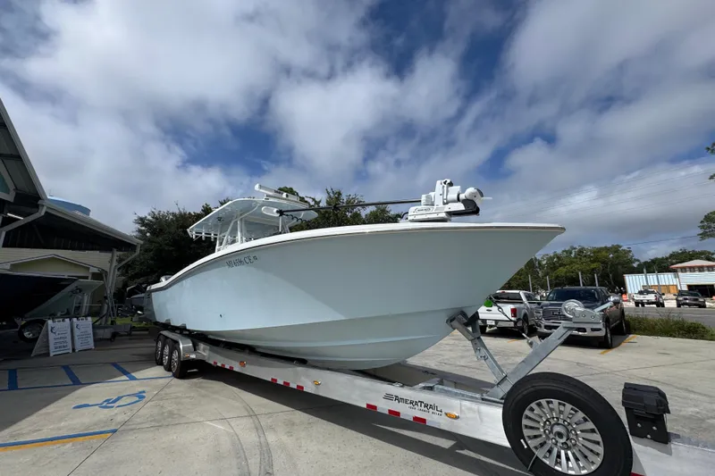  Yacht Photos Pics 2019 Invincible 39 Open Fisherman boat on trailer under cloudy sky.