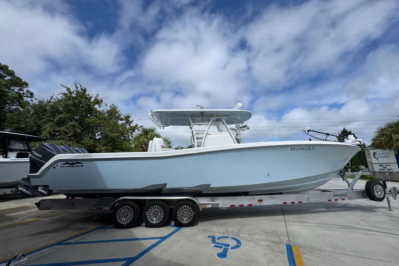  Yacht Photos Pics 2019 Invincible 39 Open Fisherman boat on trailer under cloudy sky.