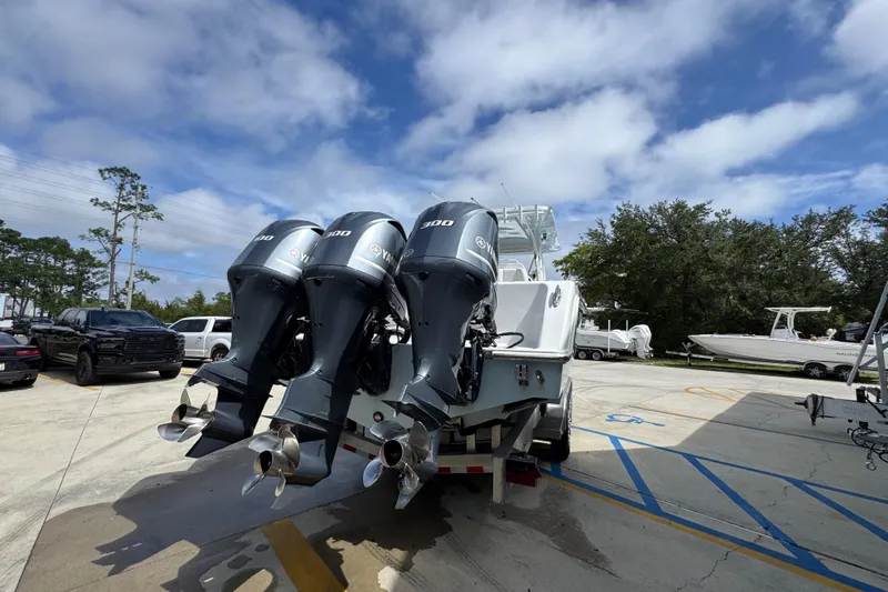  Yacht Photos Pics 2019 Invincible 39 Open Fisherman with triple outboard engines in a parking lot.